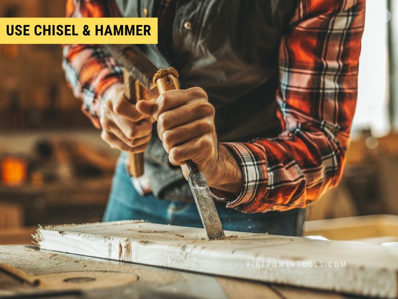 Using hammer to and chisel to cut wood