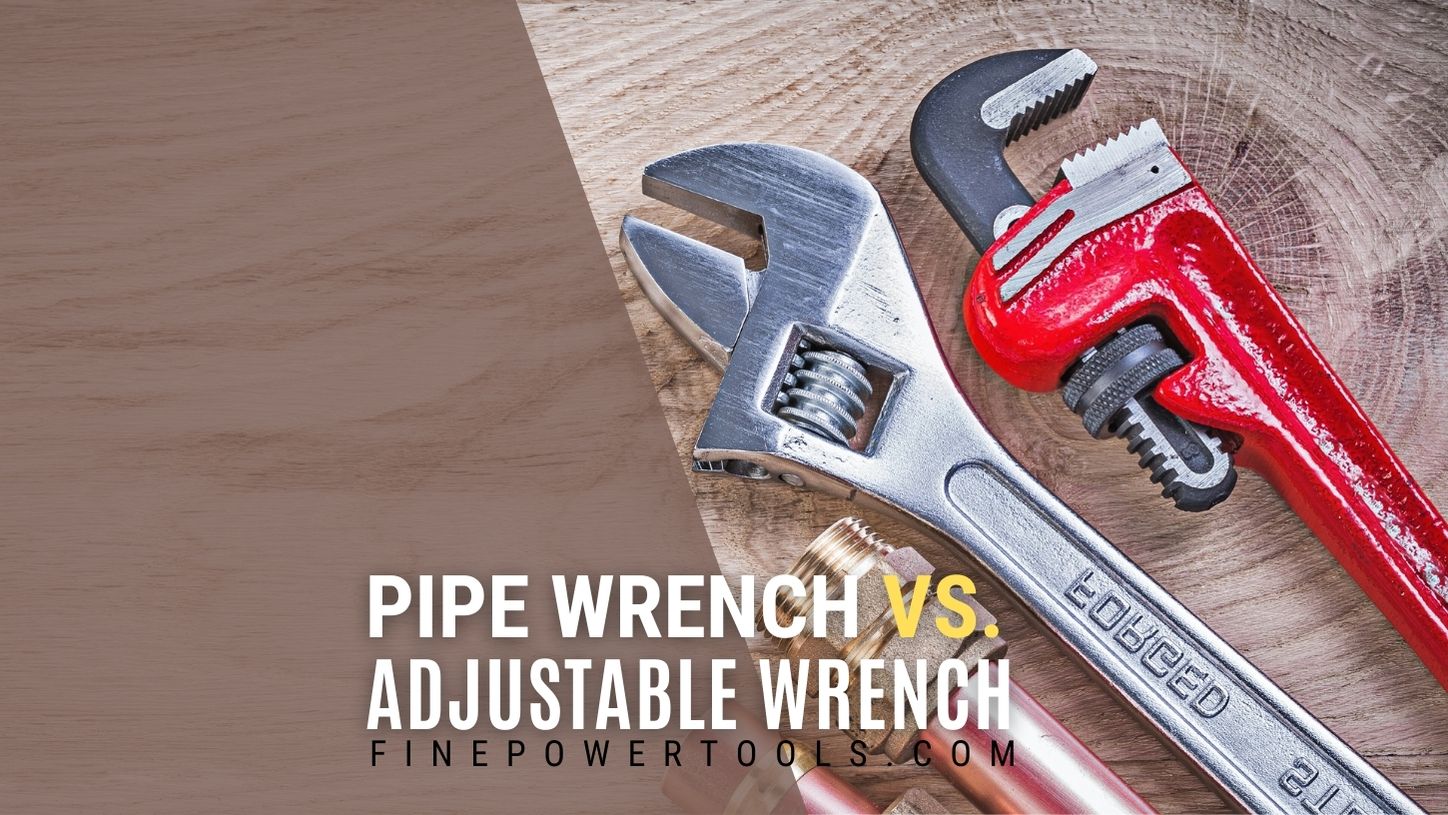 Pipe wrench and adjustable wrench on wooden table