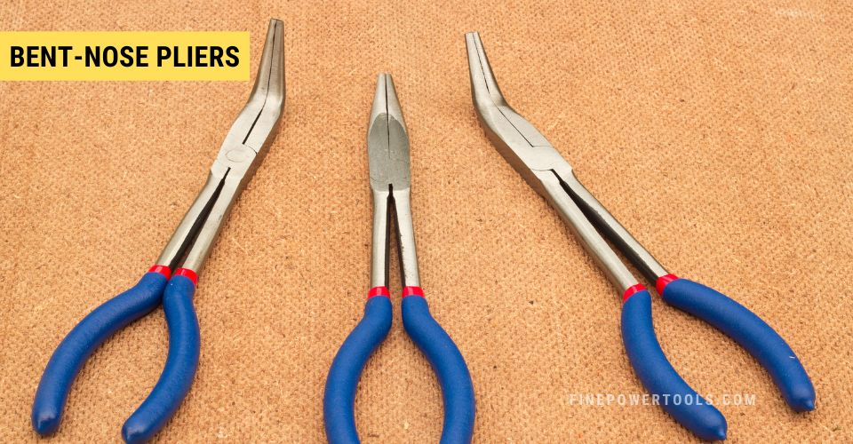 Three long Bent Nose Pliers on fabric background