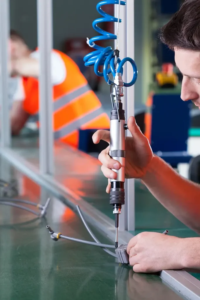 Pneumatic screwdriver at a production assembly line.