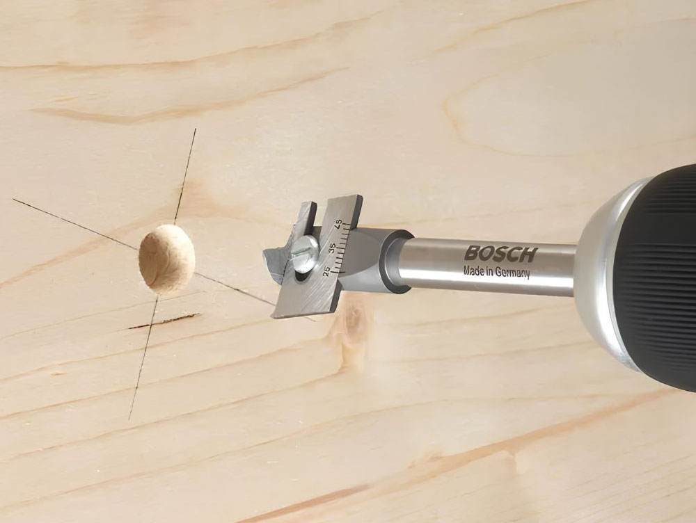 adjustable-spade-bit A Bosch adjustable Spade Bit drilling into wood.