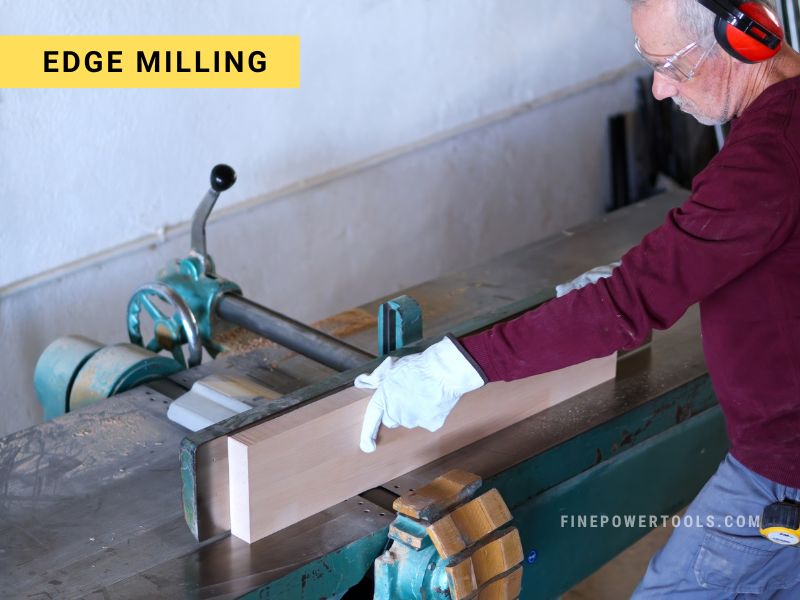 Woodworker milling the edges of a board on Jointer