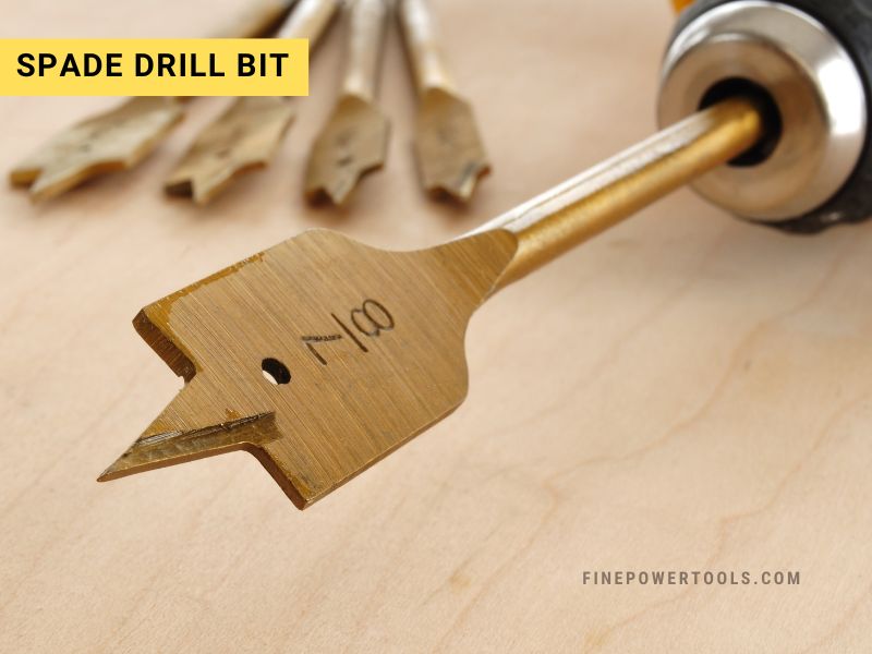 Spade Drill Bit A spade drill bit held inside a cordless drill chuck