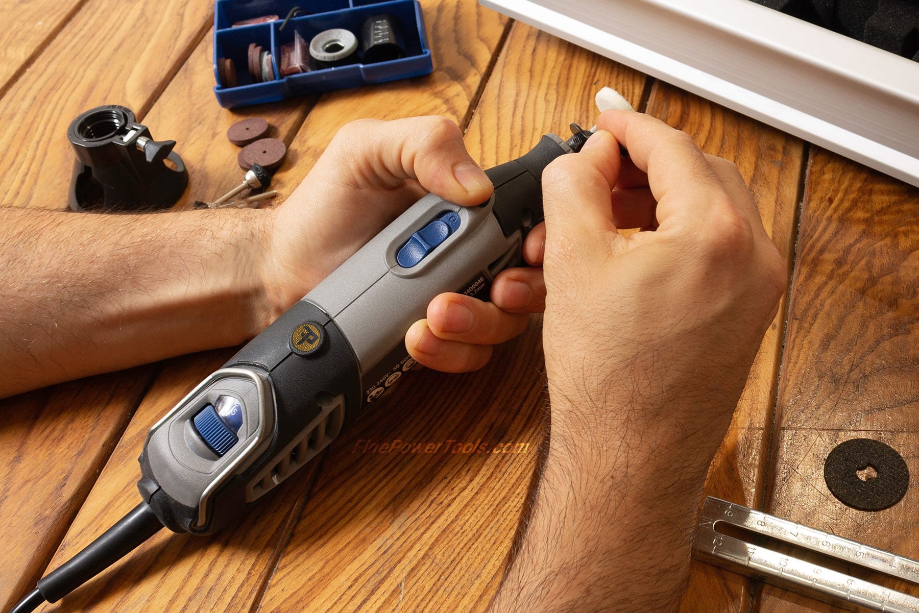 A Dremel Rotary Tool Man changing bit on a Dremel Rotary Tool for drilling
